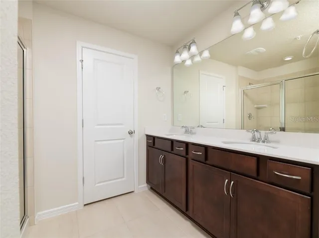 a bathroom with a double vanity sink and a mirror