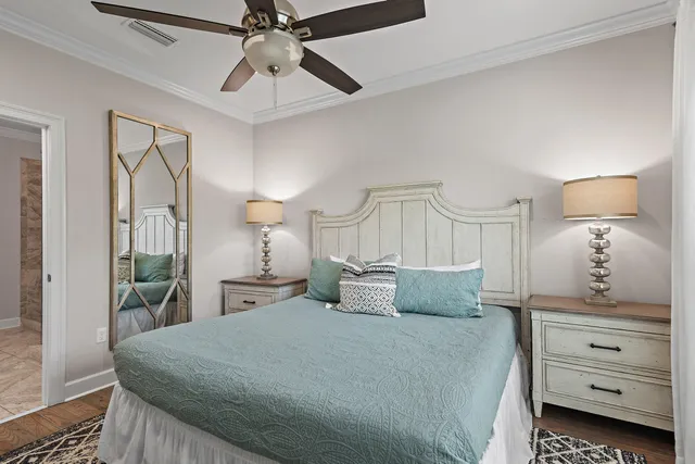 a bedroom with a bed and ceiling fan