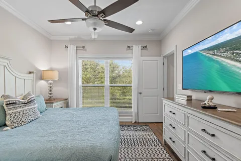 a bedroom with a large bed and a flat tv screen