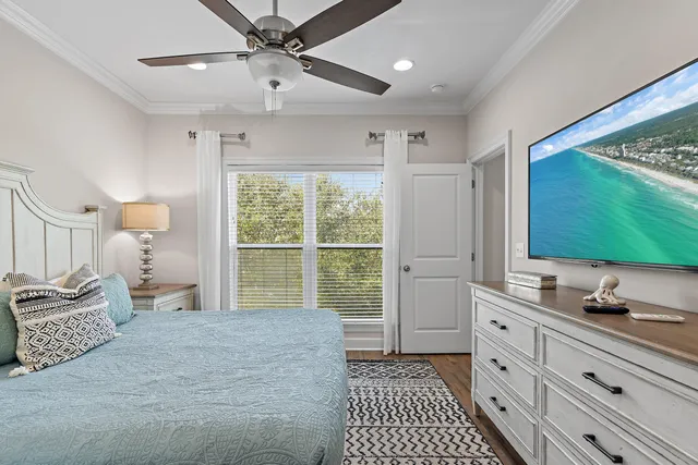 a bedroom with a large bed and a flat tv screen