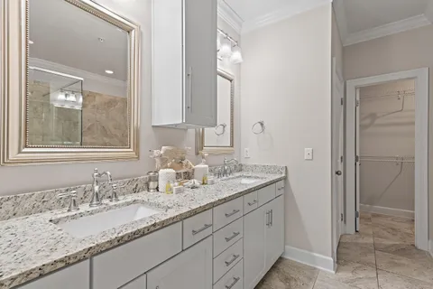a bathroom with double sink and a mirror