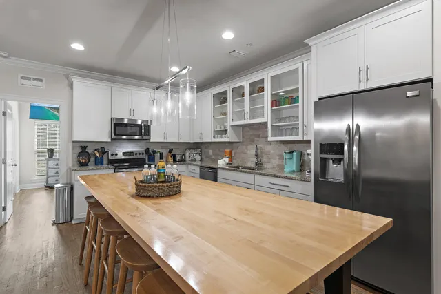 a kitchen with stainless steel appliances granite countertop a sink refrigerator and microwave