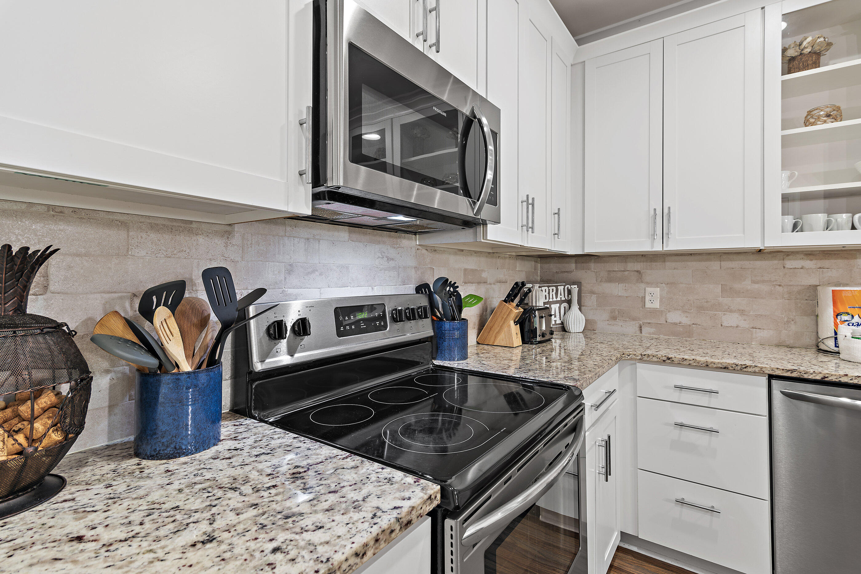 257 Driftwood Road, Unit 11 Miramar Beach, FL 32550 - Photo 10 of 40 a kitchen with granite countertop a stove top oven microwave and cabinets