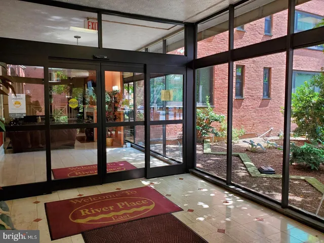 a living room with furniture a flat screen tv and a table