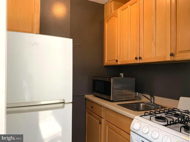 a stove top oven sitting inside of a kitchen