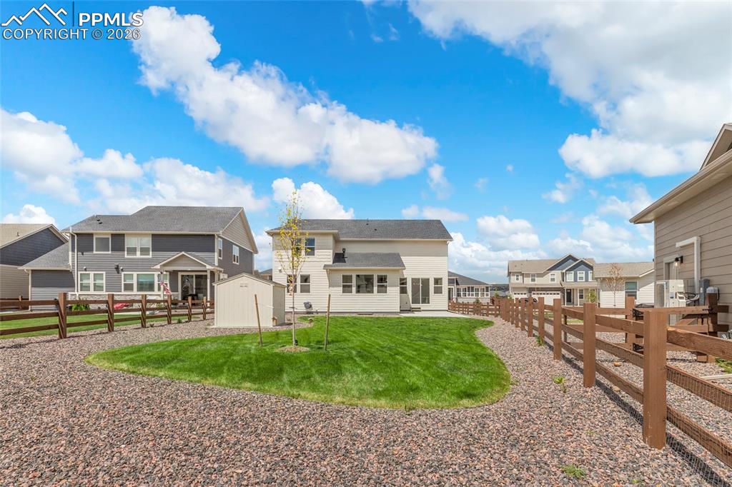 15777 Little Bluestem Road Monument, CO 80132 - Photo 50 of 50 a front view of a house with a yard and lake view