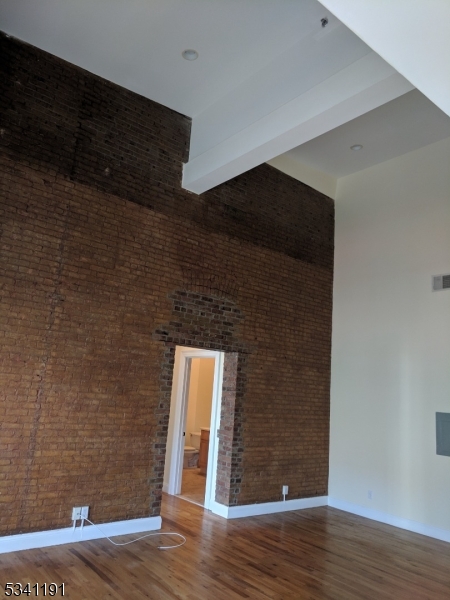 385 George Street, Unit 3B New Brunswick, NJ 08901 - Photo 9 of 18 a view of empty room with wooden floor