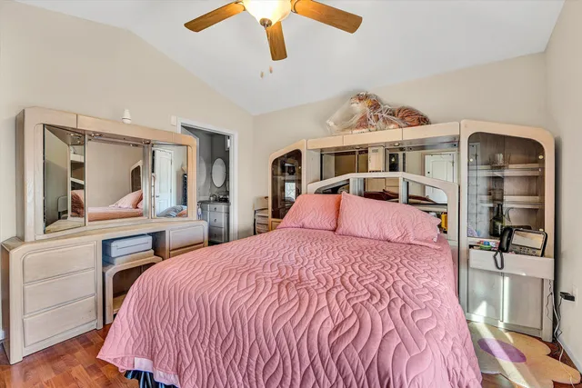 a bedroom with a large bed and a chandelier