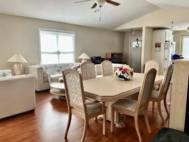 a view of a dining room with furniture and wooden floor