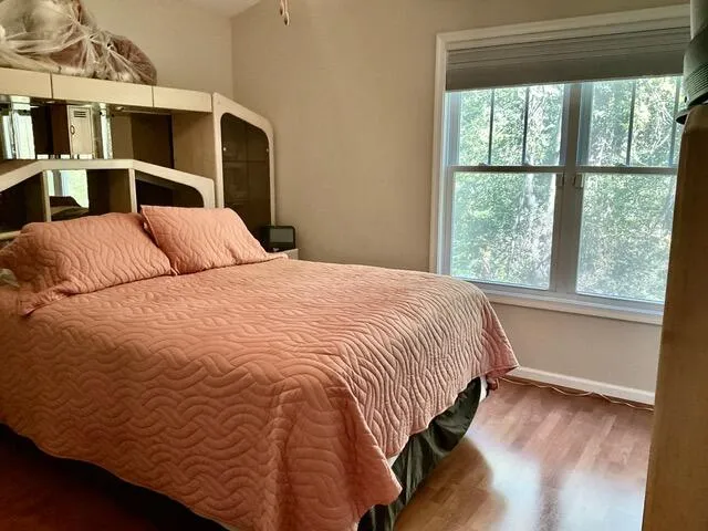 a bedroom with a bed next to a window