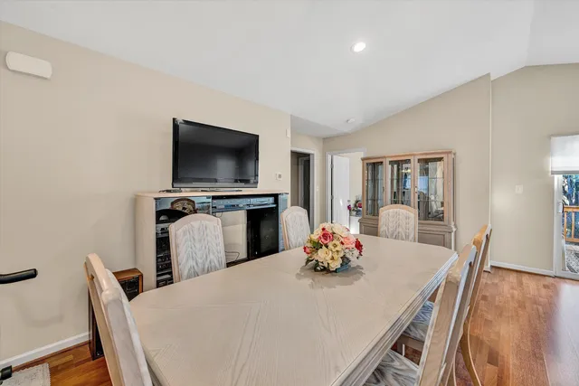 a dining room with furniture and wooden floor
