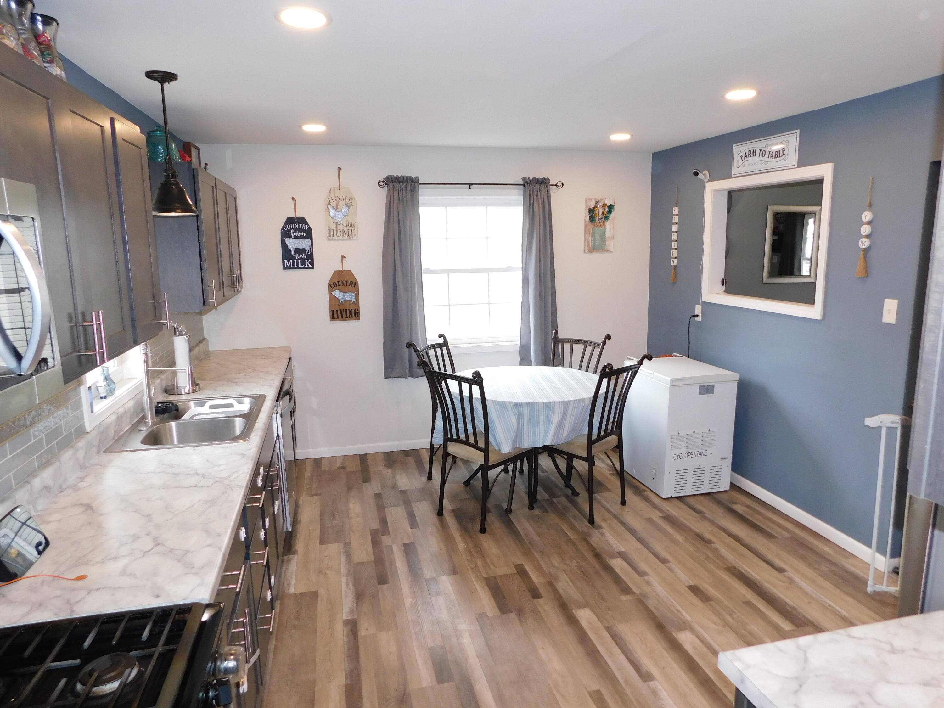 2347 Sloan Street Portage, IN 46368 - Photo 10 of 19 a view of a dining room with furniture and wooden floor