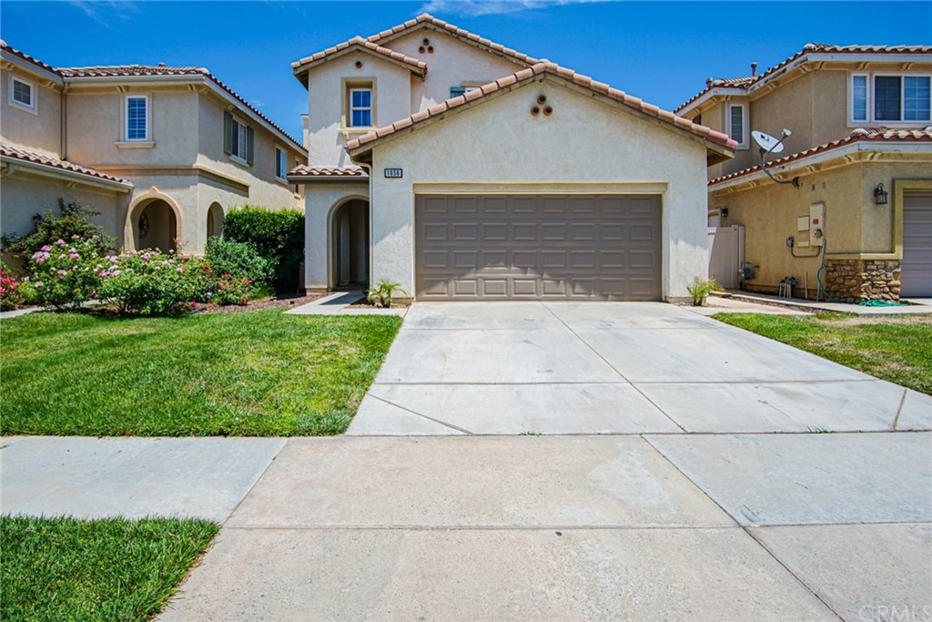 1656 Rigel Street Beaumont, CA 92223 - Photo 1 of 1 a front view of a house with a yard and garage
