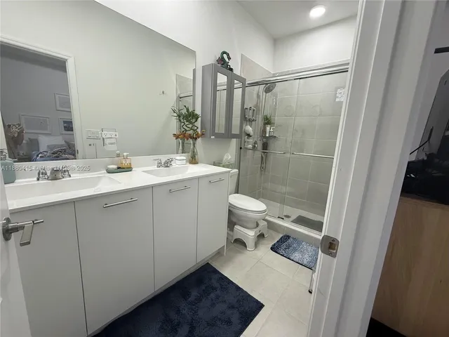 a spacious bathroom with a sink mirror toilet and shower