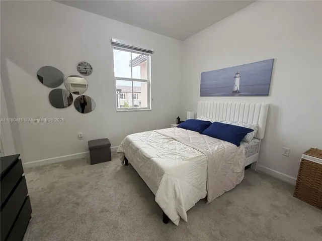 a bedroom with a bed and cabinets