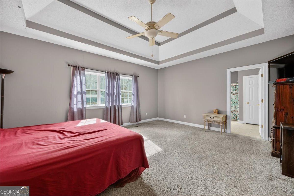 134 Royal Lane Gray, GA 31032 - Photo 14 of 31 a bedroom with a bed and a chandelier