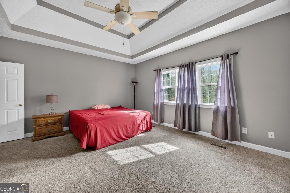 134 Royal Lane Gray, GA 31032 - Photo 15 of 31 a spacious bedroom with a bed and a chandelier