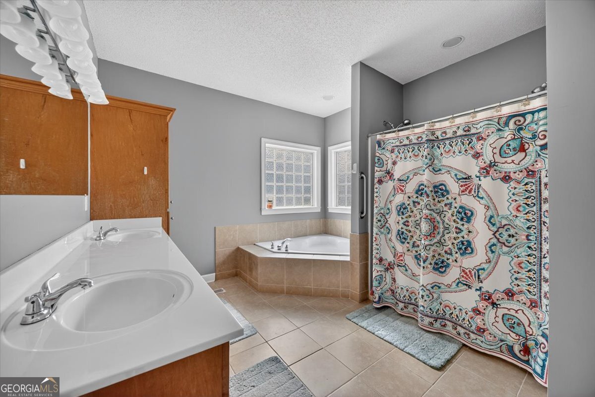 134 Royal Lane Gray, GA 31032 - Photo 16 of 31 a bathroom with a sink and a bathtub
