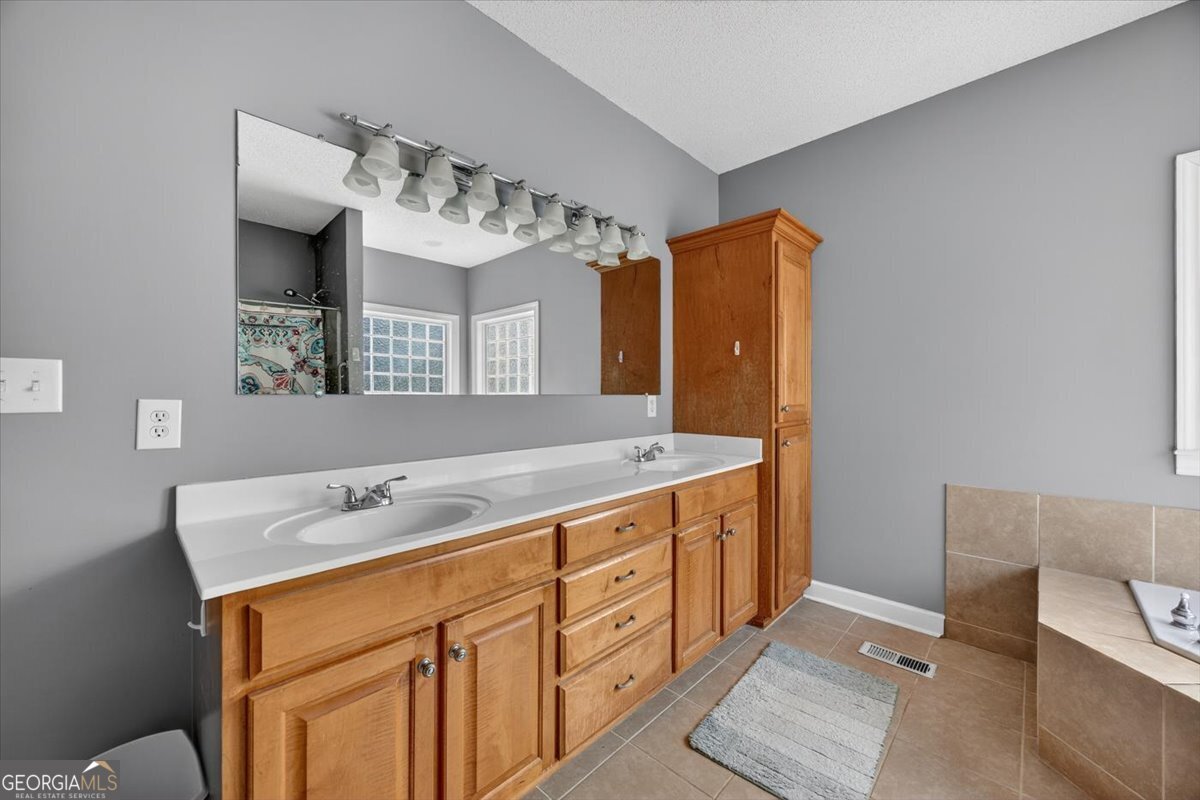 134 Royal Lane Gray, GA 31032 - Photo 17 of 31 a bathroom with a double vanity sink mirror and toilet
