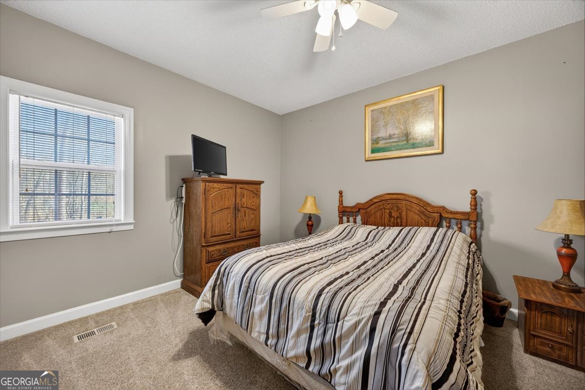 134 Royal Lane Gray, GA 31032 - Photo 20 of 31 a bedroom with a bed and a window