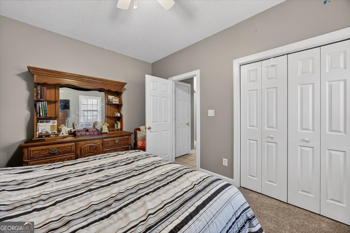 134 Royal Lane Gray, GA 31032 - Photo 21 of 31 a bedroom with a bed and a large mirror on dresser