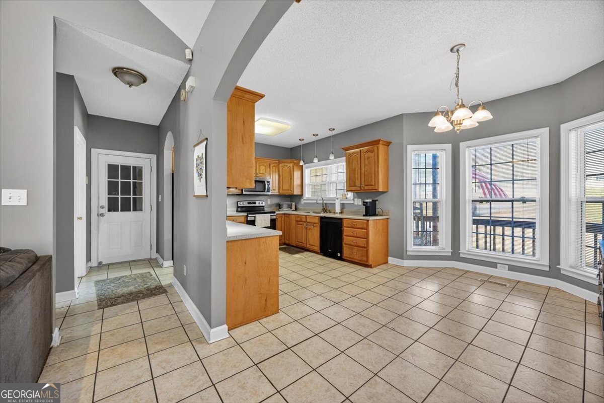 134 Royal Lane Gray, GA 31032 - Photo 8 of 31 a kitchen with stainless steel appliances granite countertop a refrigerator a stove top oven and a sink