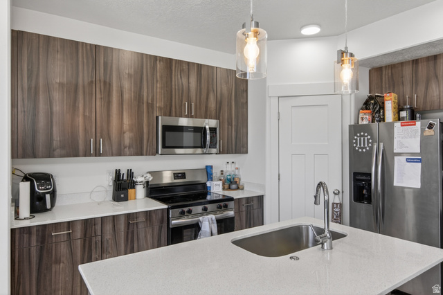 2811 South Orch Hl Lane Perry, UT 84302 - Photo 5 of 18 Kitchen featuring wood-finish cabinetry, stainless steel appliances, and quartz countertops