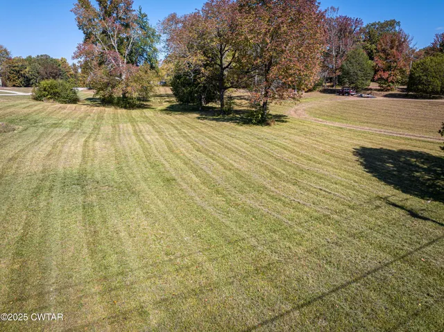 a view of empty space with wooden fence