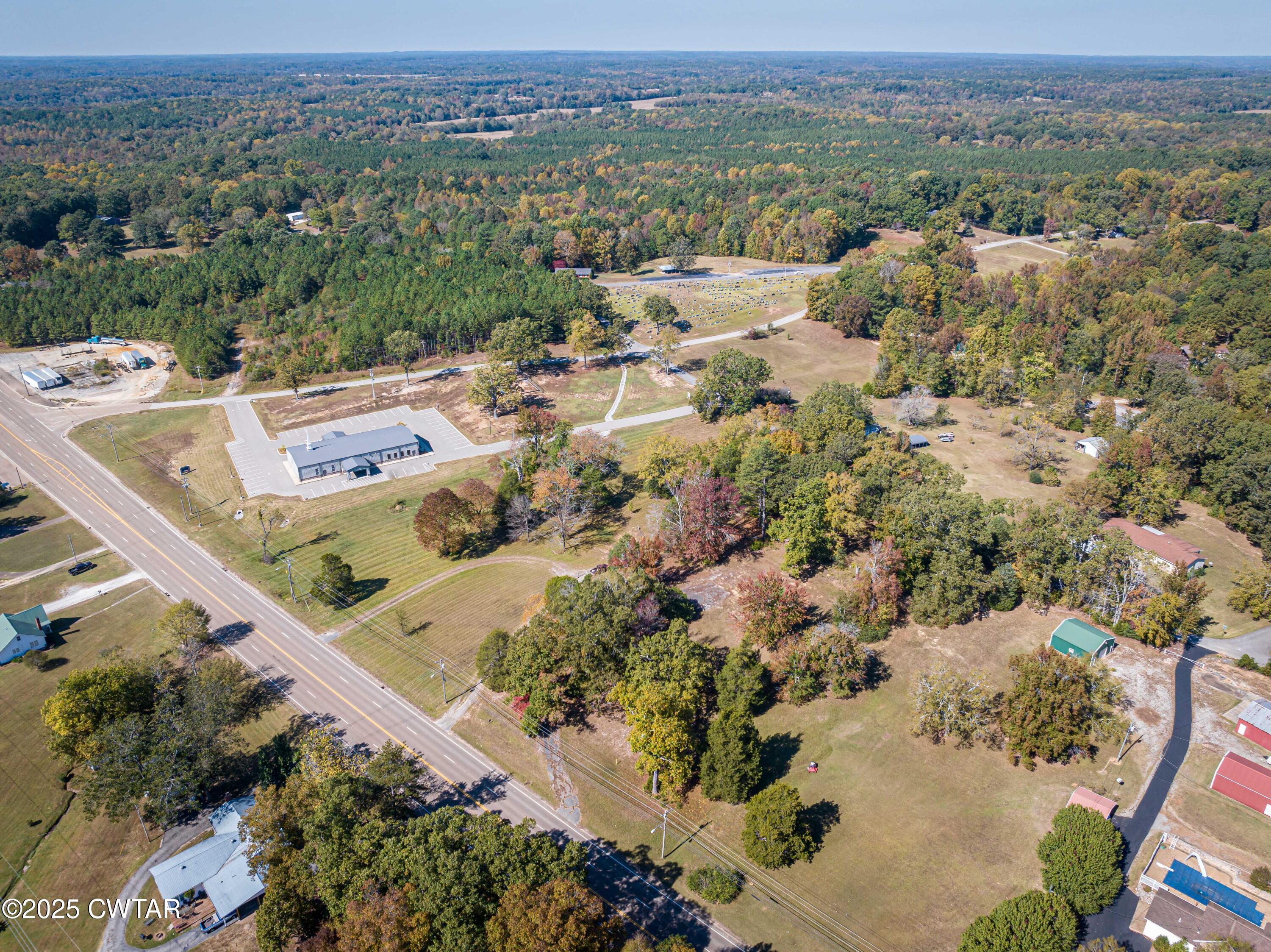 1084 West Main Street Parsons, TN 38363 - Photo 4 of 16 an aerial view of residential houses with outdoor space