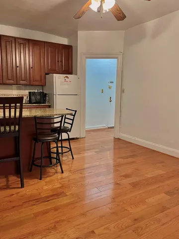 a view of a kitchen with cabinets and wooden floor