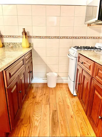 a view of a bathroom with a sink and wooden floor
