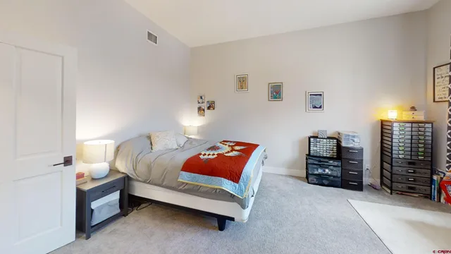 a bedroom with a bed and dresser