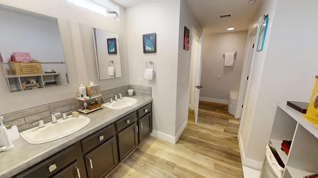 a en suite bathroom with a double vanity sink a mirror and a shower