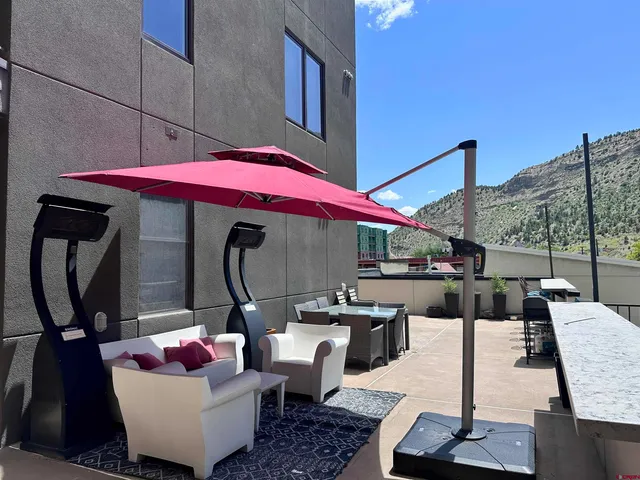 a living room with furniture a air conditioner vent and a window