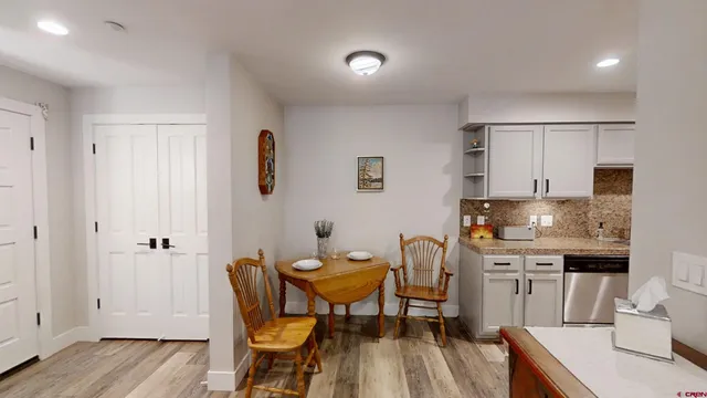 a view of a dining room with furniture and wooden floor