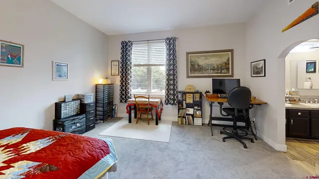 a bedroom with a bed and a desk