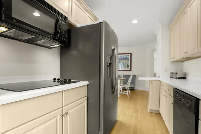 a kitchen with a sink appliances and cabinets