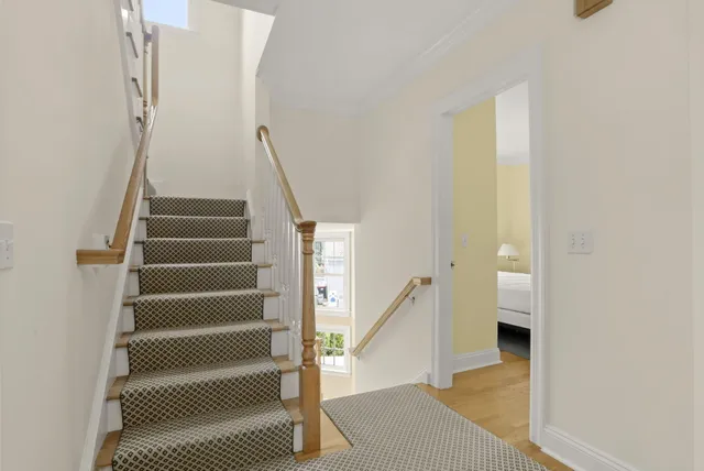 a view of entryway and hall with wooden floor