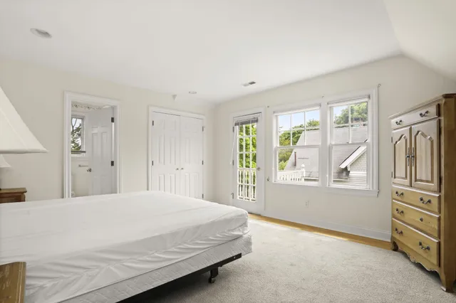 a spacious bedroom with a bed and a cabinets