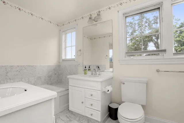a bathroom with a sink a toilet and a bathtub