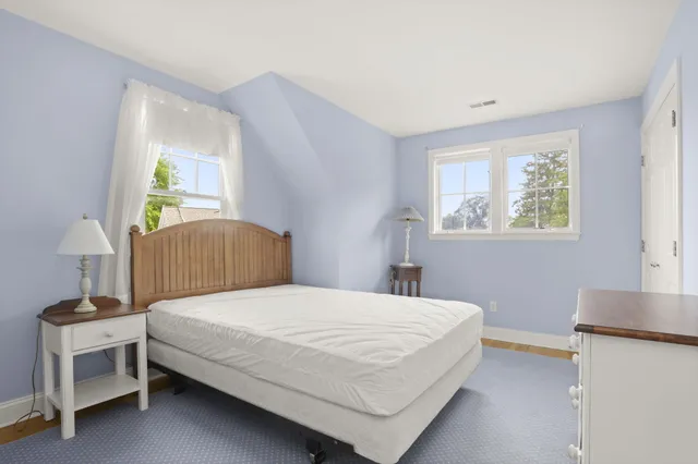 a bedroom with a bed and a table