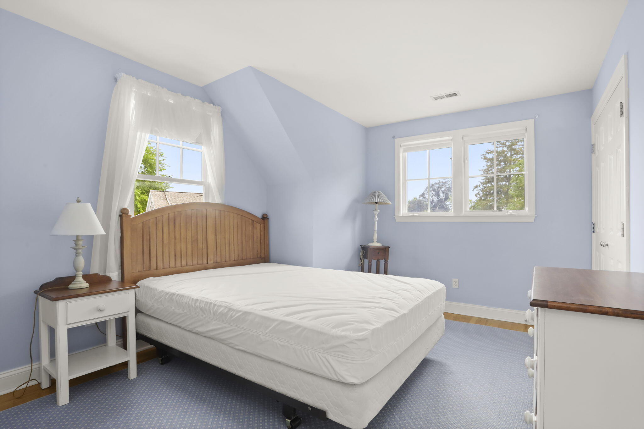 190 Main Street, Unit B New Canaan, CT 06840 - Photo 19 of 32 a bedroom with a bed and a table