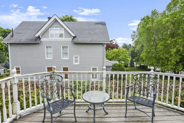 a view of a chair and table on the deck