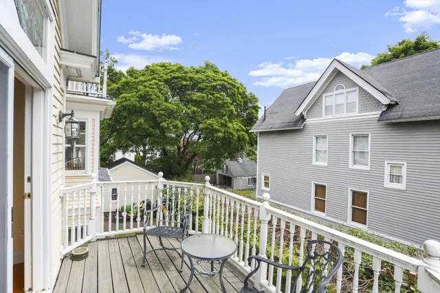 a view of a house with a wooden fence