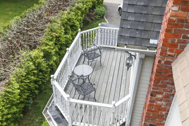a front view of a house with a yard and potted plants