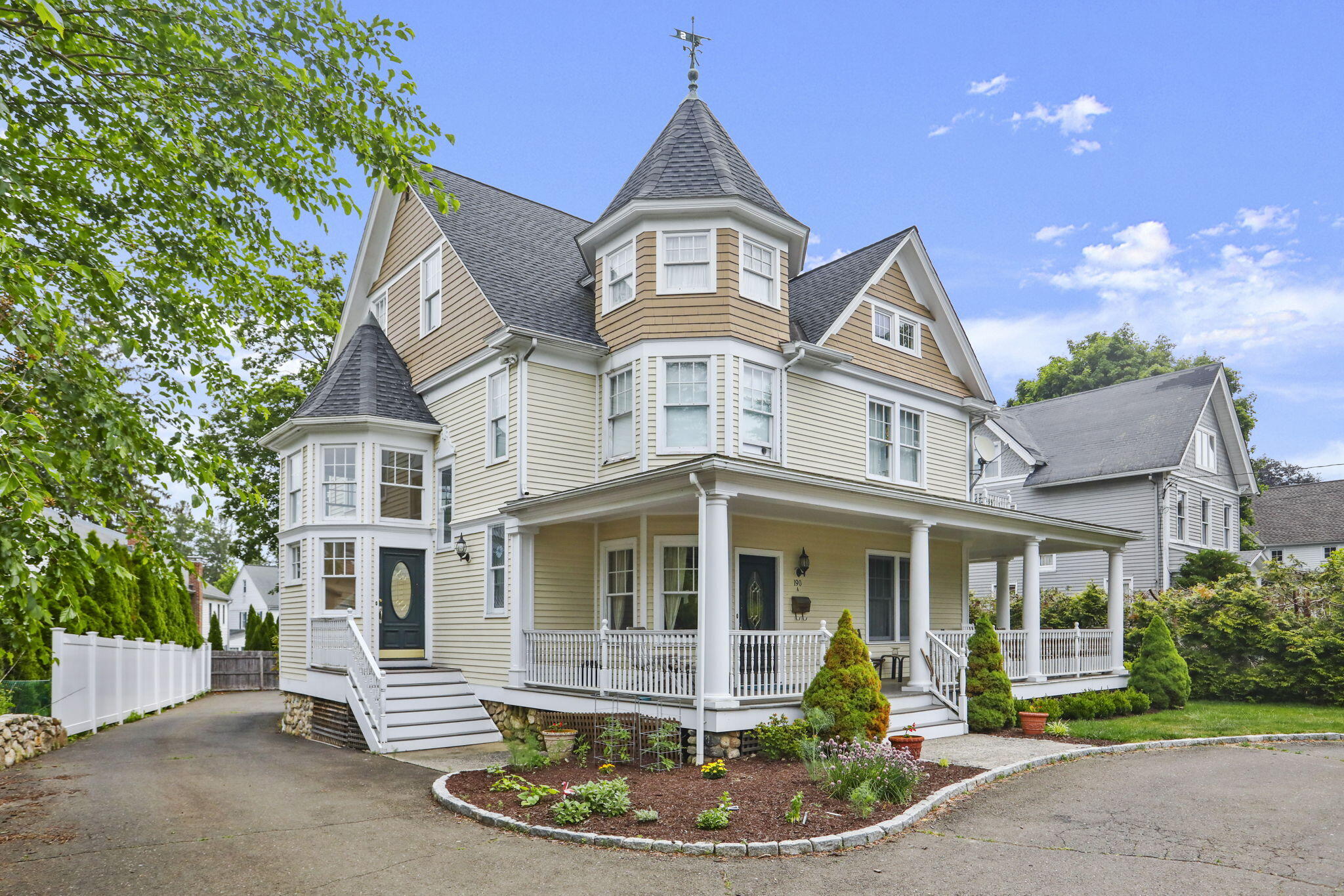 190 Main Street, Unit B New Canaan, CT 06840 - Photo 29 of 32 a front view of a house with a yard and potted plants