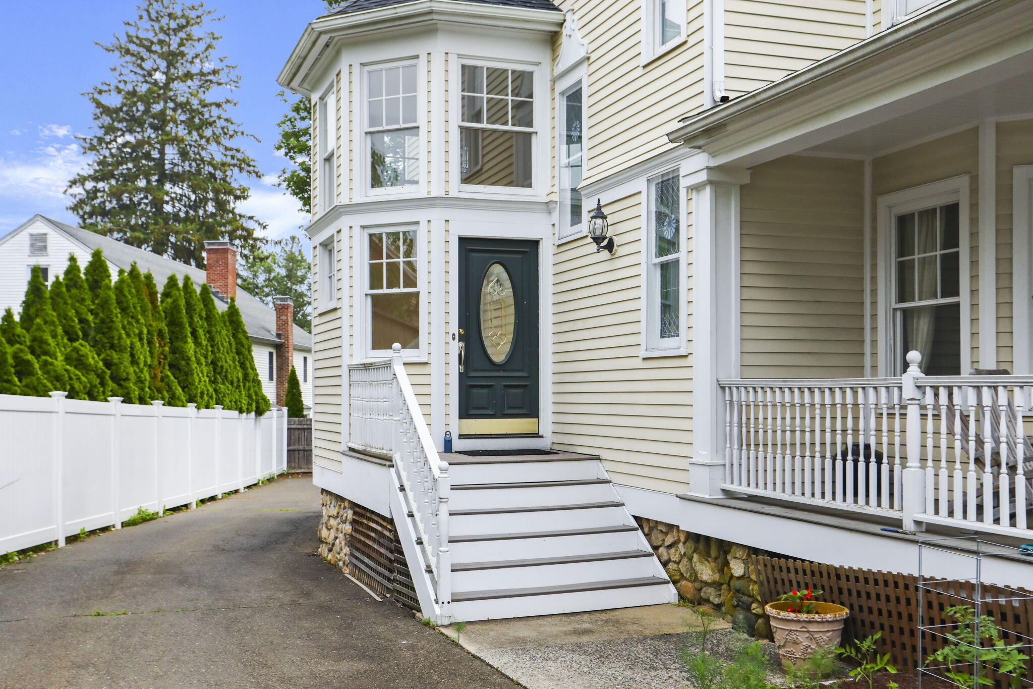 190 Main Street, Unit B New Canaan, CT 06840 - Photo 30 of 32 a view of a house with a small yard and wooden fence and large trees