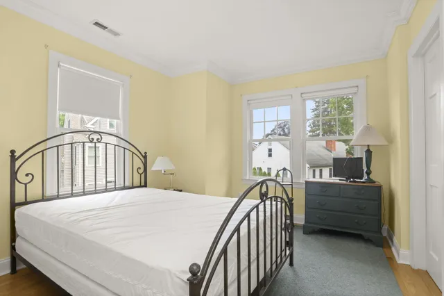 a bedroom with a bed next to a window