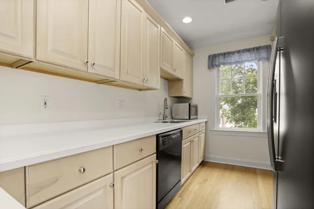 a kitchen with granite countertop white cabinets and white appliances