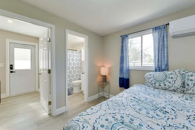 a bedroom with a bed and a window